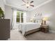 Bright bedroom featuring a comfortable bed, neutral walls, and a window view to the backyard at 383 Indian Hills Trl, Marietta, GA 30068