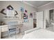 Bedroom with a desk, playful decor, carpet floors, and an open door revealing the home's stairway at 383 Indian Hills Trl, Marietta, GA 30068