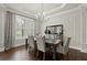 This dining room showcases elegant decor, a large window, and hardwood floors at 383 Indian Hills Trl, Marietta, GA 30068