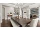 Formal dining area featuring a large table, chandelier, and entry to the study and stairway at 383 Indian Hills Trl, Marietta, GA 30068
