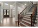 Grand foyer with hardwood floors, staircase, and elegant chandelier, a welcoming entrance at 383 Indian Hills Trl, Marietta, GA 30068