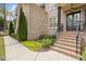 Inviting front entrance with beautiful landscaping and a decorative front door at 383 Indian Hills Trl, Marietta, GA 30068
