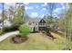 Charming home with lush front lawn, mature trees, and inviting curb appeal at 383 Indian Hills Trl, Marietta, GA 30068