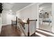 Second floor hallway features hardwood floors, view into living area with built-ins at 383 Indian Hills Trl, Marietta, GA 30068