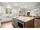 This spacious kitchen island provides seating, storage, and workspace with a sink, stainless appliances, and an oven at 383 Indian Hills Trl, Marietta, GA 30068