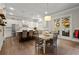 Bright kitchen features a large island, stainless appliances, and a dining area with access to the outdoor space at 383 Indian Hills Trl, Marietta, GA 30068