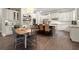 Kitchen featuring white cabinets, stainless steel appliances, an island with bar seating, and an adjacent dining area at 383 Indian Hills Trl, Marietta, GA 30068