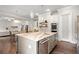 Open kitchen layout with an island, stainless steel appliances, granite countertops, and access to living areas at 383 Indian Hills Trl, Marietta, GA 30068