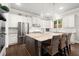 A bright kitchen with stainless steel appliances, a large island, white cabinets, and modern fixtures at 383 Indian Hills Trl, Marietta, GA 30068