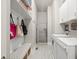 Well-organized laundry room with storage shelves, bench, and a stacked washer and dryer at 383 Indian Hills Trl, Marietta, GA 30068