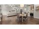 Open-concept living room with coffered ceilings, hardwood floors, and a combined kitchen and dining area at 383 Indian Hills Trl, Marietta, GA 30068
