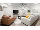 Spacious living room with a TV, lots of natural light and modern furniture at 383 Indian Hills Trl, Marietta, GA 30068