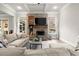 Cozy living room with a brick fireplace, coffered ceiling, and large sectional sofa at 383 Indian Hills Trl, Marietta, GA 30068