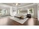 Spacious main bedroom featuring hardwood floors, sitting area, and a decorative tray ceiling at 383 Indian Hills Trl, Marietta, GA 30068