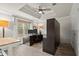 Bright home office featuring modern furnishings, a ceiling fan, and a large window overlooking the backyard at 383 Indian Hills Trl, Marietta, GA 30068
