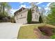 Spacious home featuring a two-car garage and a well-maintained lawn at 383 Indian Hills Trl, Marietta, GA 30068