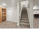 A neutral staircase connects the floors, complemented by wood-look tile and built-in shelving at 383 Indian Hills Trl, Marietta, GA 30068