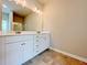 Bright bathroom with double vanity, a large mirror with vanity lighting, and stylish tile flooring at 5119 Aylesbury Ct, Hoschton, GA 30548