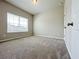 Bright bedroom featuring a large window and neutral-toned carpet, creating a comfortable atmosphere at 5119 Aylesbury Ct, Hoschton, GA 30548