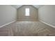 Bright bedroom featuring carpet floors and natural light from one window at 5119 Aylesbury Ct, Hoschton, GA 30548