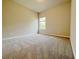 Bright bedroom featuring carpet floors and natural light from one window at 5119 Aylesbury Ct, Hoschton, GA 30548
