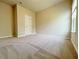 Neutral bedroom with a large window, plush carpet, and a bright interior, perfect for relaxing and unwinding at 5119 Aylesbury Ct, Hoschton, GA 30548
