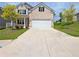 Charming two-story brick home with an attached two-car garage, manicured lawn, and beautiful landscaping at 5119 Aylesbury Ct, Hoschton, GA 30548