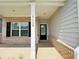 Inviting front porch with brick accents, white columns, and clear house number display at 5119 Aylesbury Ct, Hoschton, GA 30548