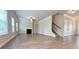 Spacious living room features a fireplace, hardwood floors, and an open floor plan with stairway at 5119 Aylesbury Ct, Hoschton, GA 30548