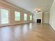 Bright living room featuring wood flooring, fireplace, crown molding and abundant natural light from many windows at 5119 Aylesbury Ct, Hoschton, GA 30548