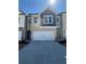 Charming brick townhome with a two-car garage, well-maintained landscaping, and inviting curb appeal at 5645 Hislop Ln # 89, Mableton, GA 30126