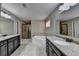 Bathroom with double vanities, a soaking tub, and a walk-in shower with a glass door at 7130 Rocking Horse Ln, Cumming, GA 30040