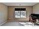 Neutral bedroom with carpeted floors, bright light, and a sunny view at 7130 Rocking Horse Ln, Cumming, GA 30040