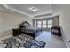 Bright bedroom with tray ceiling, neutral walls, carpeted floors, and a large window at 7130 Rocking Horse Ln, Cumming, GA 30040