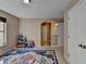 bedroom with neutral walls, area rug, natural light and play area at 7130 Rocking Horse Ln, Cumming, GA 30040