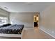 Bedroom with carpeted floors, bright natural light, and ensuite bathroom at 7130 Rocking Horse Ln, Cumming, GA 30040