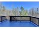 Outdoor deck area surrounded by a lush wooded landscape, perfect for relaxation at 7130 Rocking Horse Ln, Cumming, GA 30040