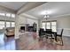Open-concept dining room featuring dark hardwood floors and a elegant chandelier at 7130 Rocking Horse Ln, Cumming, GA 30040