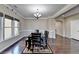 Bright dining room features dark wood table, hardwood floors, and elegant chandelier at 7130 Rocking Horse Ln, Cumming, GA 30040