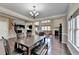Open floor plan with dining area adjacent to living room with hardwood floors at 7130 Rocking Horse Ln, Cumming, GA 30040