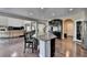 Open kitchen and living space with a large island, granite countertops, and hardwood floors at 7130 Rocking Horse Ln, Cumming, GA 30040