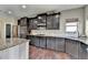 Elegant kitchen featuring dark cabinets, stainless appliances, and granite countertops at 7130 Rocking Horse Ln, Cumming, GA 30040