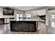 Gourmet kitchen featuring a large island, stainless appliances, and ample storage at 7130 Rocking Horse Ln, Cumming, GA 30040