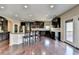 Gourmet kitchen with stainless steel appliances, dark wood cabinetry, and granite countertops at 7130 Rocking Horse Ln, Cumming, GA 30040