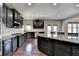 Chef's kitchen with stainless steel appliances, granite countertops, and a large island at 7130 Rocking Horse Ln, Cumming, GA 30040