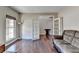 Spacious living room with hardwood floors, and French doors at 7130 Rocking Horse Ln, Cumming, GA 30040