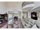 Open-concept living room featuring dark wood floors, a cozy seating area, and balcony at 7130 Rocking Horse Ln, Cumming, GA 30040