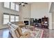 Inviting living room with a cozy fireplace, plush leather seating, and hardwood floors at 7130 Rocking Horse Ln, Cumming, GA 30040