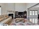 Cozy living room with a fireplace, hardwood floors, and an open layout at 7130 Rocking Horse Ln, Cumming, GA 30040