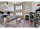 Spacious living room boasts hardwood floors, soaring ceilings, and a cozy fireplace at 7130 Rocking Horse Ln, Cumming, GA 30040